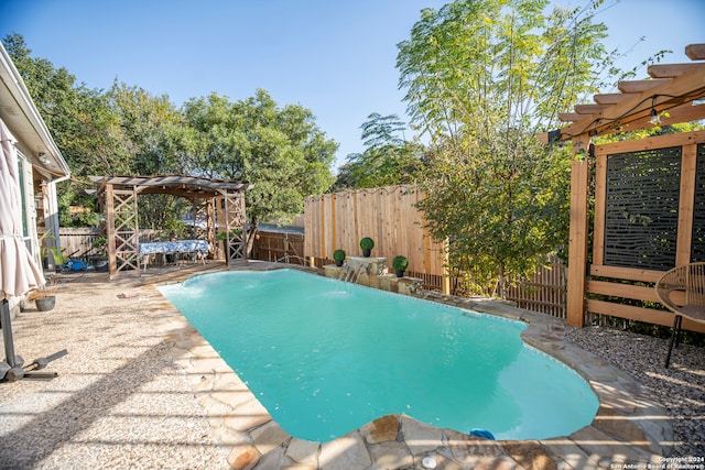 view of swimming pool with a pergola and pool water feature