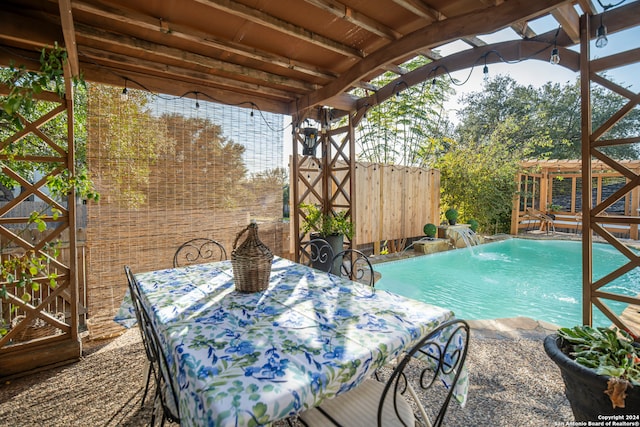 view of pool featuring pool water feature and a pergola