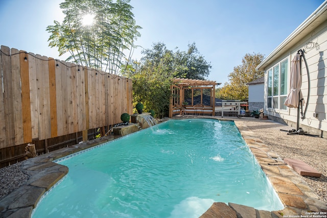 view of swimming pool featuring pool water feature and a pergola