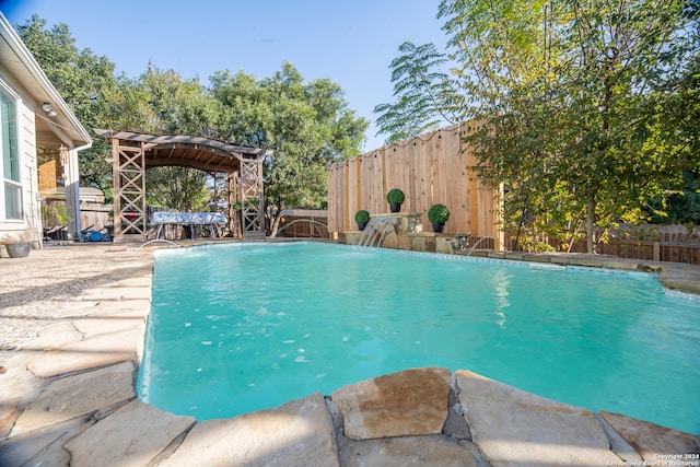 view of swimming pool with pool water feature