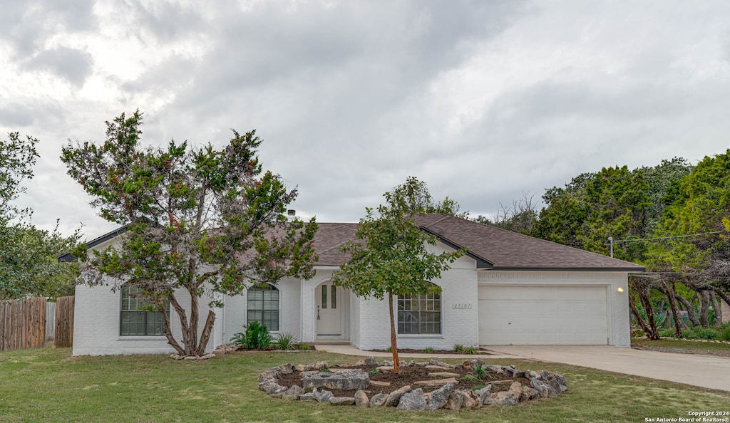 view of front facade with a front lawn and a garage