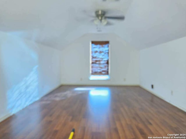 bonus room featuring ceiling fan, dark hardwood / wood-style flooring, and lofted ceiling