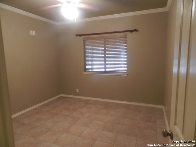 unfurnished room with crown molding and ceiling fan