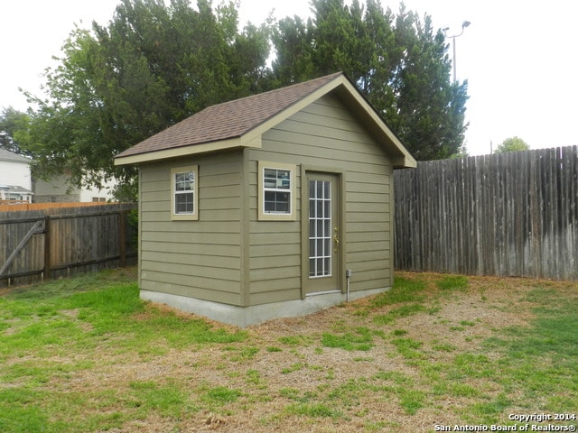 view of outbuilding with a lawn