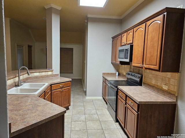 kitchen featuring crown molding, sink, decorative backsplash, light tile patterned floors, and appliances with stainless steel finishes