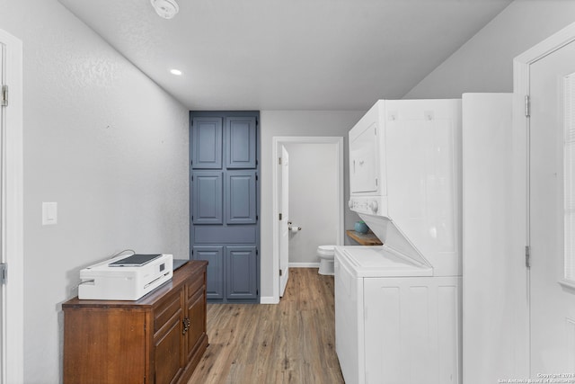 washroom featuring stacked washer / dryer and hardwood / wood-style floors