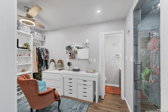 spacious closet featuring ceiling fan and dark wood-type flooring