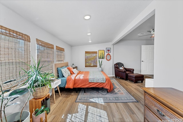 bedroom with light hardwood / wood-style flooring and lofted ceiling