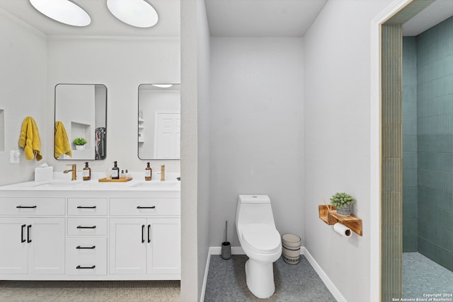 bathroom with vanity, toilet, and a tile shower