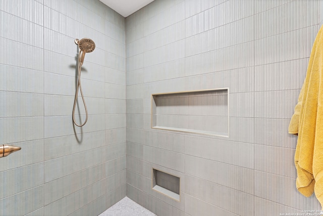 bathroom with a tile shower