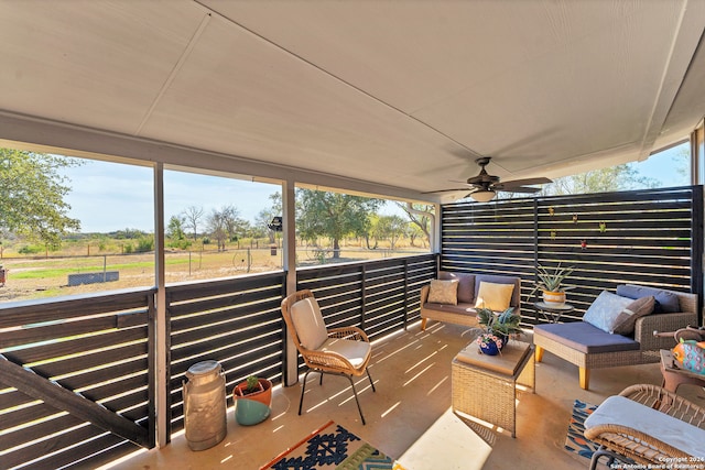 exterior space featuring ceiling fan, a healthy amount of sunlight, and a rural view