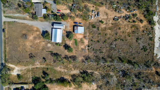 birds eye view of property with a rural view