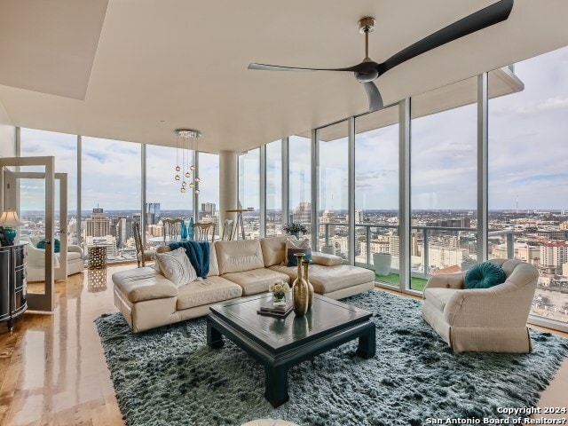 sunroom featuring ceiling fan