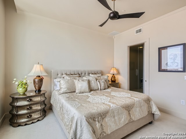 bedroom featuring carpet flooring, ceiling fan, and crown molding