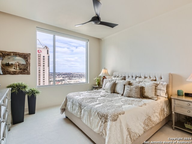 carpeted bedroom with ceiling fan