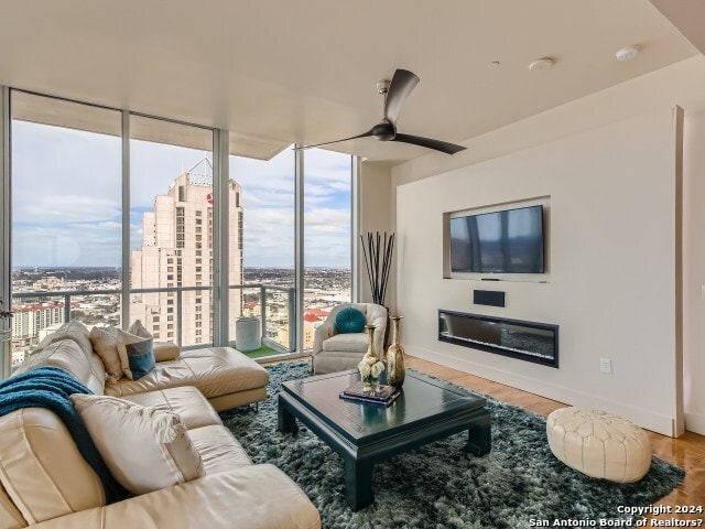 living room with ceiling fan and hardwood / wood-style floors