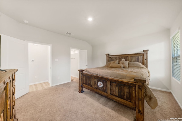 carpeted bedroom with lofted ceiling