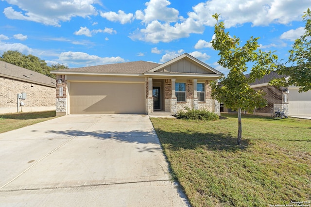 view of front facade with a porch, a garage, and a front yard