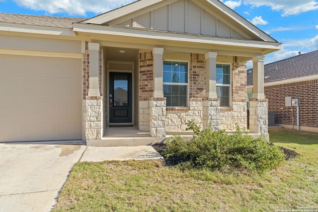 view of front facade with a front lawn, a porch, and a garage