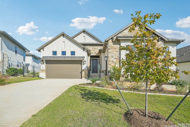 view of front of property with a garage and a front lawn