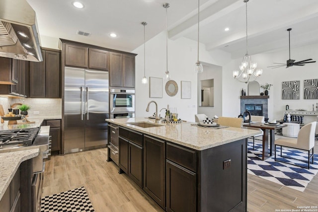23422 Grande Vis, San Antonio, TX 78261 - kitchen featuring stainless steel appliances, island exhaust hood, beamed ceiling, backsplash, and a sink