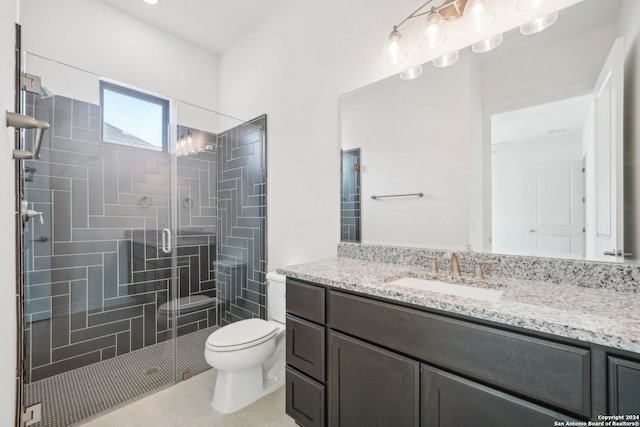 bathroom featuring vanity, a shower with shower door, tile patterned floors, and toilet