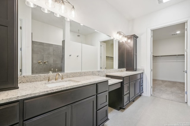 bathroom featuring a shower, tile patterned floors, and vanity