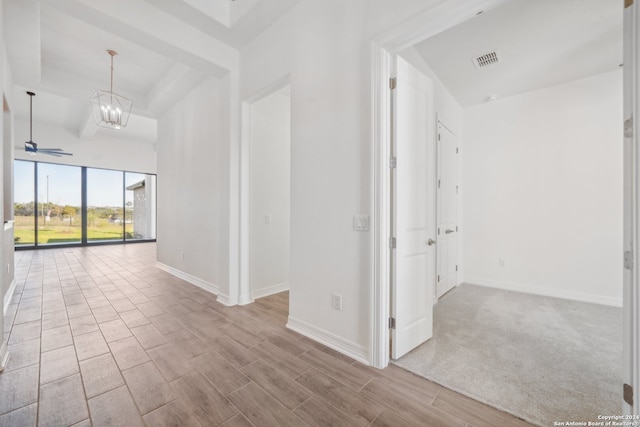 hall featuring an inviting chandelier