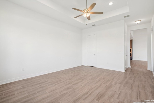 23422 Grande Vis, San Antonio, TX 78261 - empty room featuring a tray ceiling, light wood-style floors, ceiling fan, baseboards, and recessed lighting