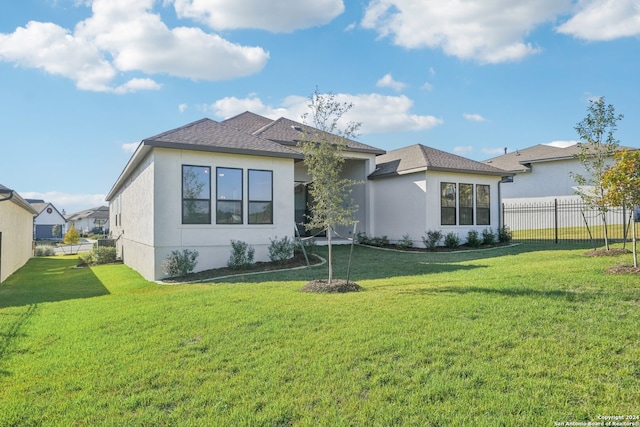 back of house with a lawn