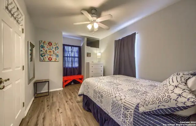 bedroom with wood-type flooring and ceiling fan