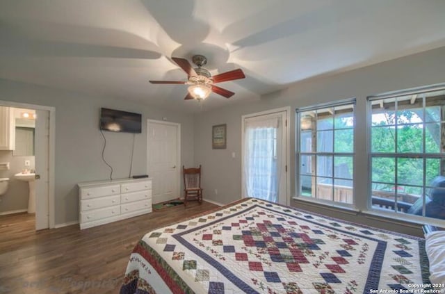 bedroom with ceiling fan, dark wood-type flooring, and connected bathroom