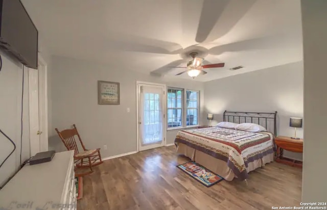 bedroom with ceiling fan and dark wood-type flooring