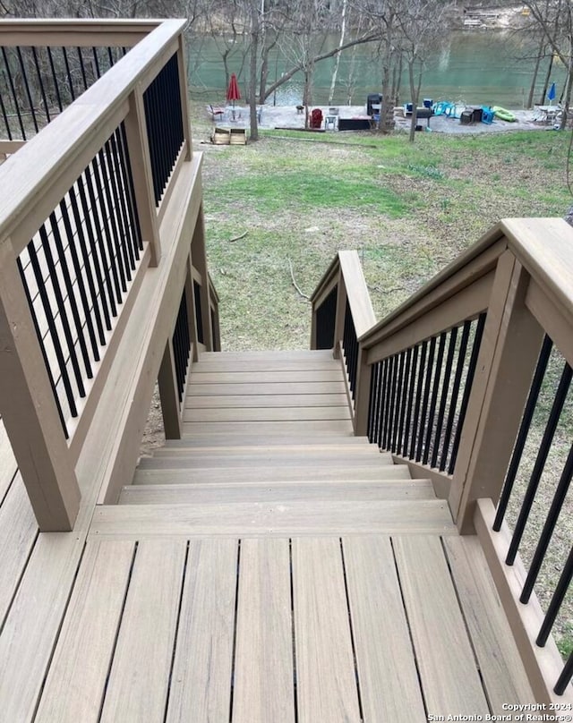 wooden deck with a lawn