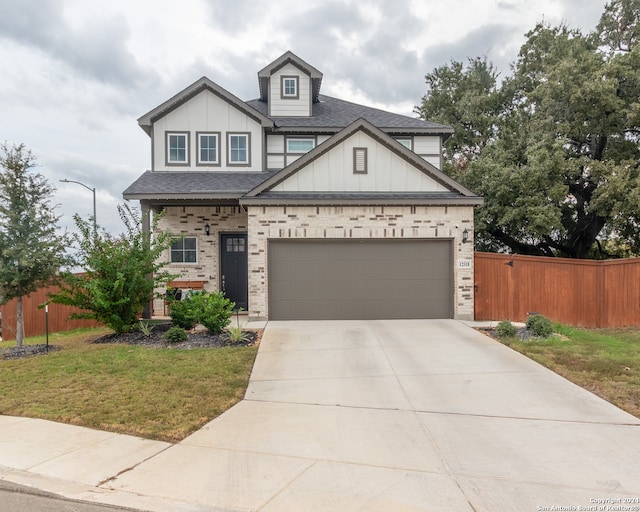 view of front of house featuring a garage and a front lawn