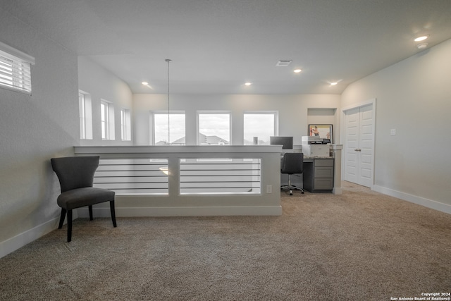 interior space featuring light colored carpet and lofted ceiling