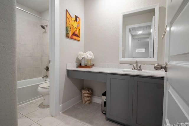 full bathroom with tile patterned flooring, vanity, tiled shower / bath combo, and toilet