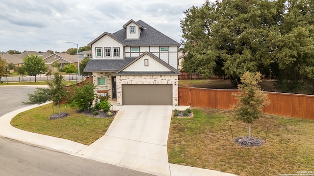 view of front of house featuring a garage and a front lawn