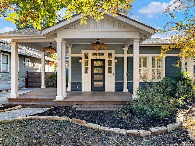 doorway to property with ceiling fan and a porch