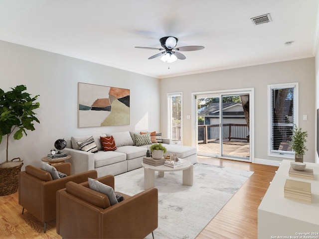 living room with light hardwood / wood-style flooring, ceiling fan, and ornamental molding