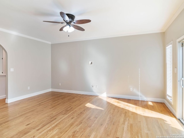 spare room featuring light hardwood / wood-style floors, a wealth of natural light, and ornamental molding