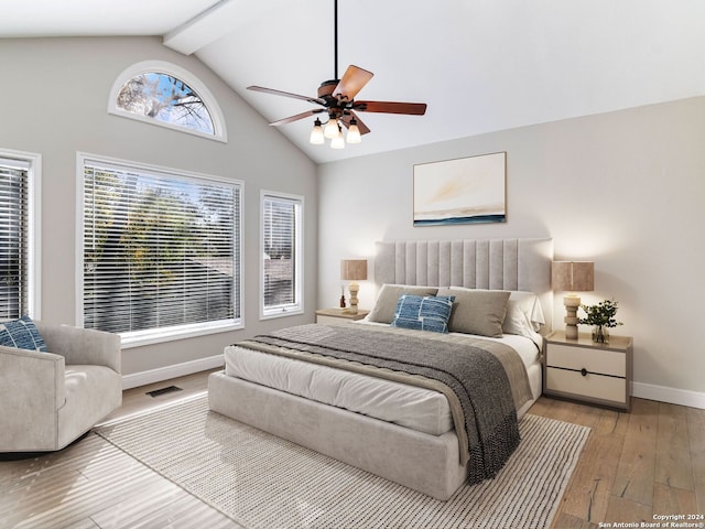 bedroom featuring beamed ceiling, hardwood / wood-style floors, high vaulted ceiling, and ceiling fan