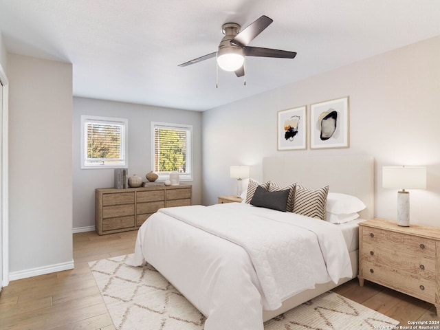 bedroom with ceiling fan and light hardwood / wood-style flooring