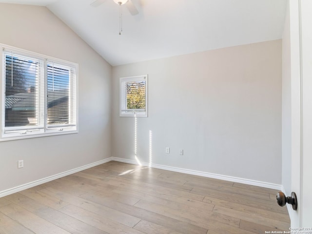 unfurnished room with ceiling fan, vaulted ceiling, and light hardwood / wood-style flooring