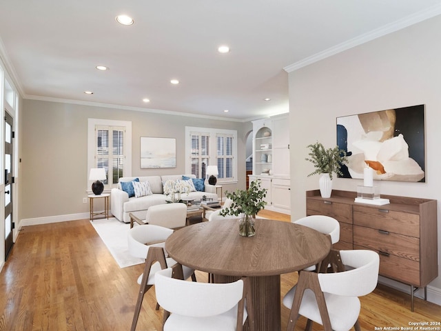 dining space featuring light hardwood / wood-style flooring and ornamental molding