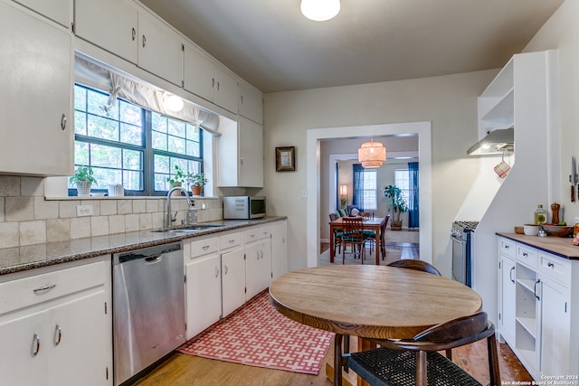 kitchen with white cabinets, sink, light wood-type flooring, and stainless steel appliances