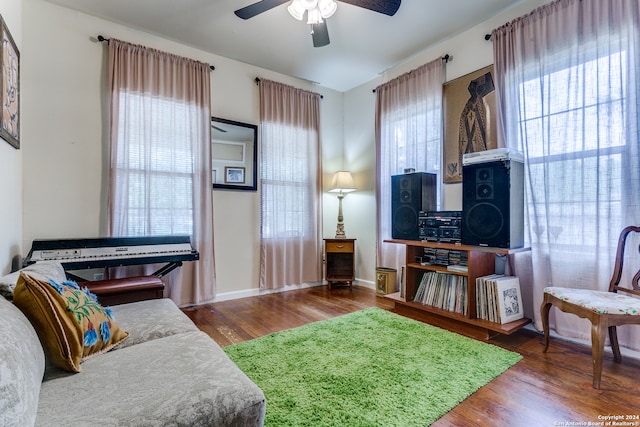 living room featuring hardwood / wood-style floors and ceiling fan