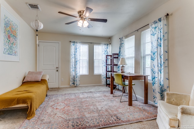 office area with light colored carpet, a wealth of natural light, and ceiling fan