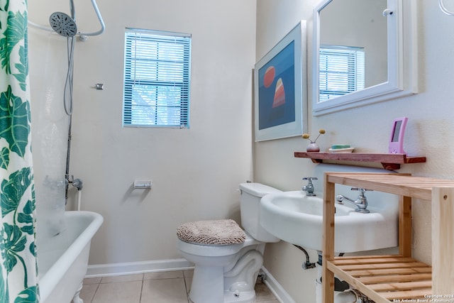 bathroom with tile patterned floors, shower / bath combo, and toilet