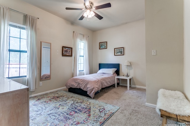 bedroom with ceiling fan and light colored carpet